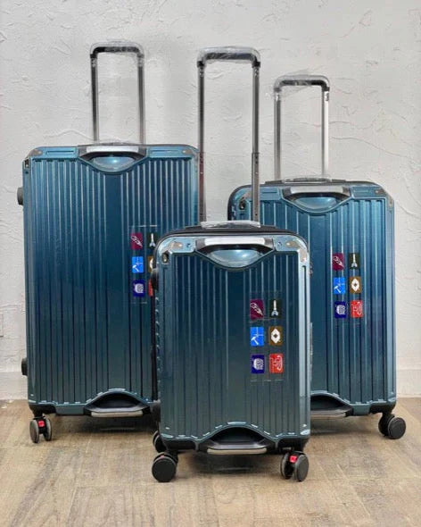 Set of blue suitcases with visible brand logos on a light gray background